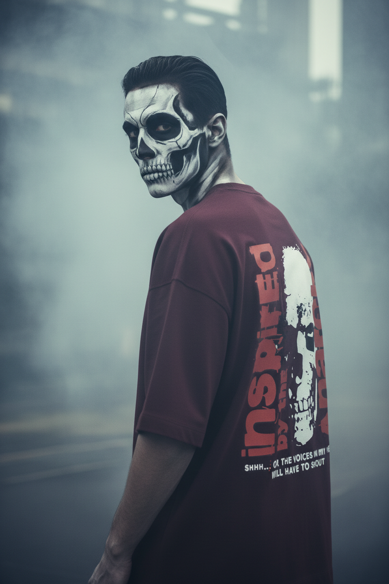Person wearing a maroon t-shirt with a skull design and text in a smoky indoor setting